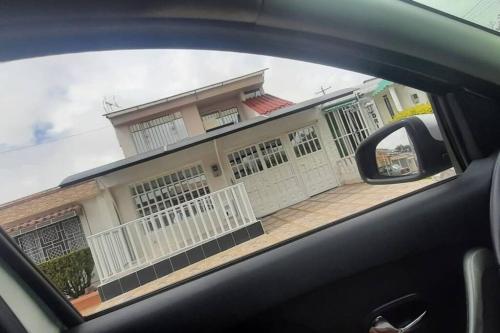 a view of a house from the side view mirror of a car at Hermoso ¡Apartamento! en Fusagasugá! in Fusagasuga