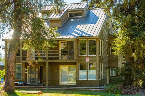 a house with a metal roof on top of it at Snowbird Condo 195 - C in Girdwood