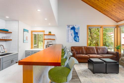 a kitchen and living room with a table and a couch at Snowbird Condo 195 - C in Girdwood