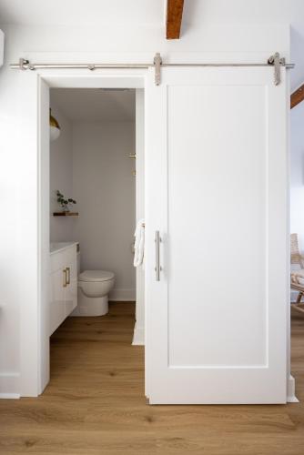 an open door in a bathroom with a toilet at Inn on the Beach in Harwich Port