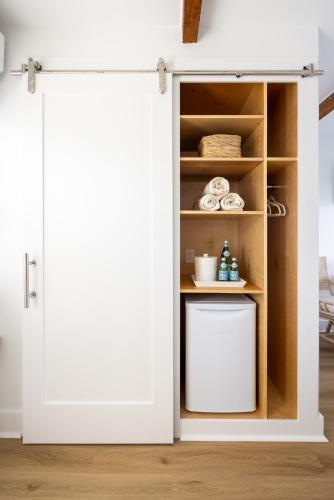 an open door into a kitchen with a shelf at Inn on the Beach in Harwich Port