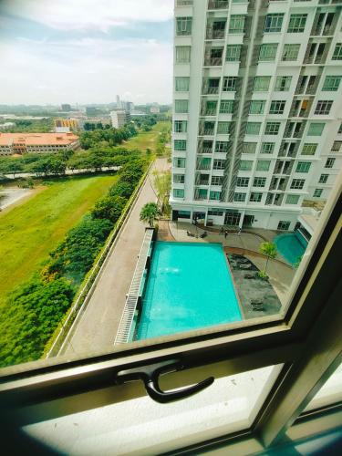 a view of a swimming pool from a window in a building at Peace home in Cyberjaya