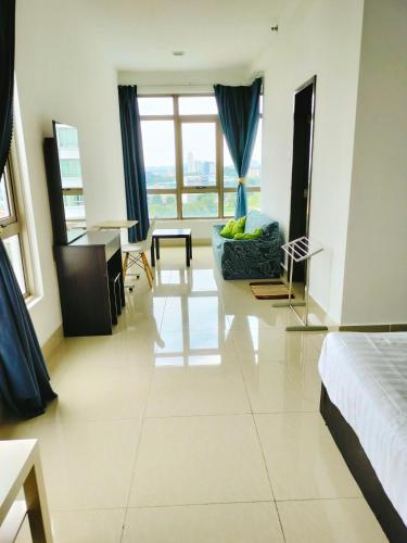 a bedroom with a bed and a living room at Peace home in Cyberjaya