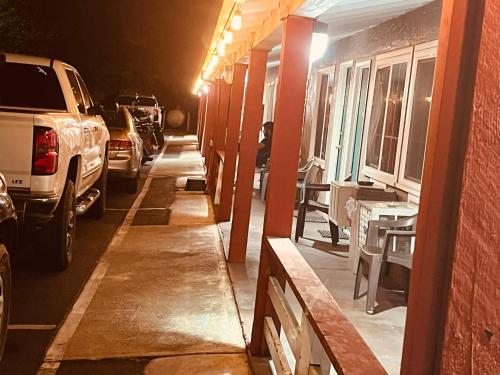 a street at night with cars parked next to a building at Jumping Frog Motel in Angels Camp