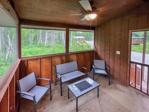 a room with two chairs and a table with a laptop on it at Talkeetna Wilderness Lodge & Cabin Rentals in Sunshine