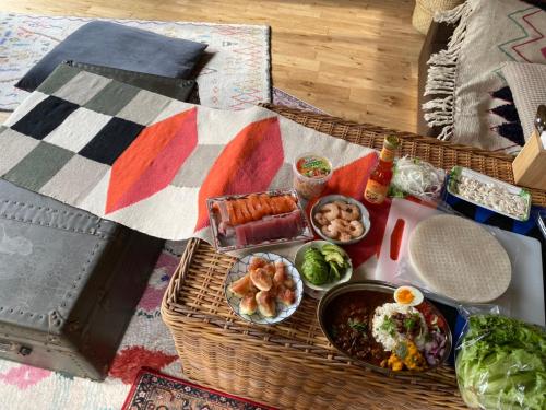 a picnic basket filled with food on a table at ゲストハウスよるよなか in Nagoya