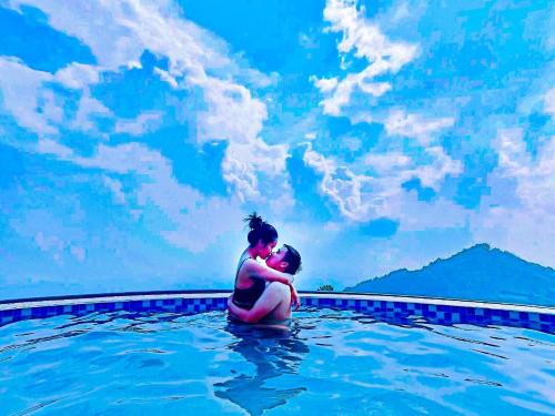 a woman sitting in a swimming pool at Sun Villa Tam Đảo in Vĩnh Phúc