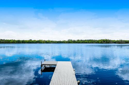 a dock in the middle of a large lake at Whispering Pines in Harshaw