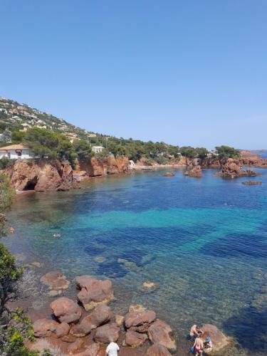 a body of water with people swimming in it at Grand mobilhome spacieux 8 places frejus/straphael in Fréjus