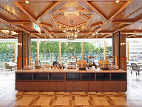 a large room with a salon with a counter and windows at Chisun Hotel Yokohama Isezakicho in Yokohama