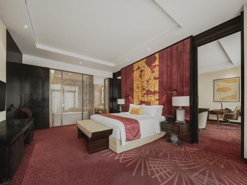 a hotel room with a bed and a bathroom at Gran Melia Xi'an in Xi'an
