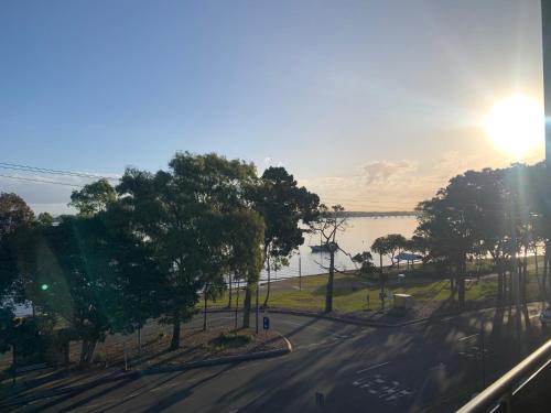 a view of a street with trees and a lake at Keith's on Pumicestone, 1 of the 3 most popular units on Bribie in Bongaree