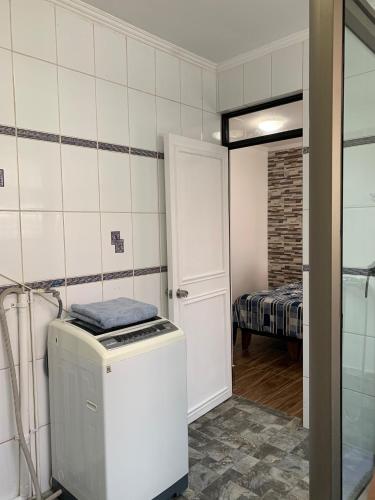 a kitchen with a washer and dryer in a room at Apart Hotel Vicencio Iquique in Iquique