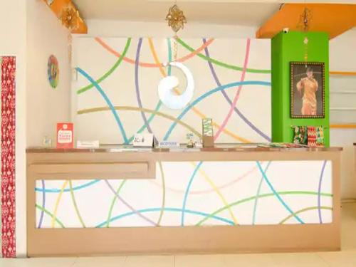 a desk in a room with a colorful wall at Dewarna Hotel Arifin in Malang