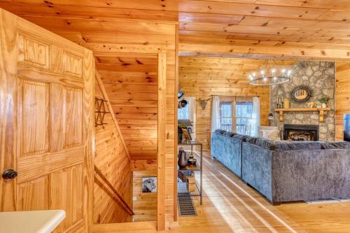 a living room with a wooden wall and a door at MTN Cabin Sleeps 10 - 5 Mins To Fishing & Camping in Ellijay