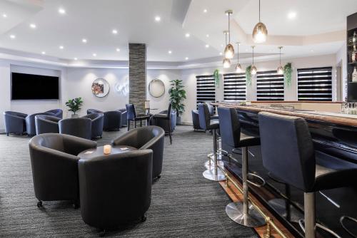 a bar in a waiting room with chairs at Quality Hotel Melbourne Airport in Melbourne