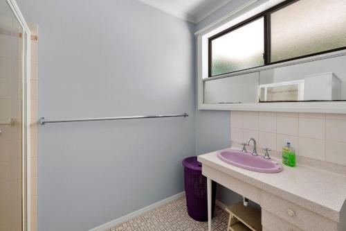 a bathroom with a sink and a shower at Retro Retreat in Lorne