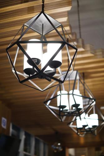a chandelier hanging from a ceiling with lights at Cordela Senen Jakarta in Jakarta