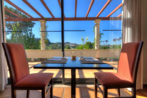 a dining room with a table and two chairs at Lam Hotel Estarreja in Estarreja