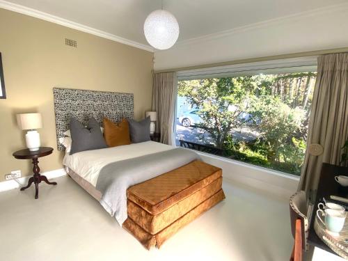 a bedroom with a bed and a large window at 182 Old Transkei Road in East London
