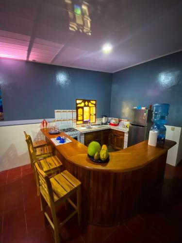 a kitchen with a island in the middle of a room at Hostal tortuga viajera in Moyogalpa
