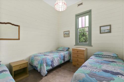 a bedroom with two beds and a window at Rivernook in Anglesea