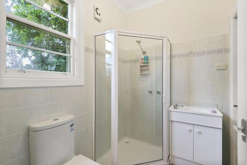 a bathroom with a shower and a toilet and a sink at Rivernook in Anglesea
