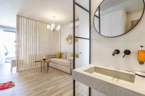 a living room with a sink and a mirror at Alkionides Apartments in Polychrono