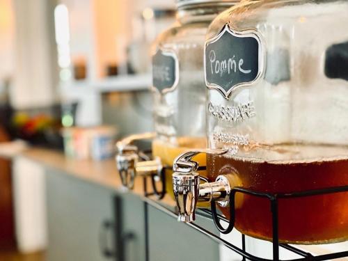 a jar of honey on a counter in a kitchen at Hotel Le Midi Clermont-Cournon in Cournon-dʼAuvergne