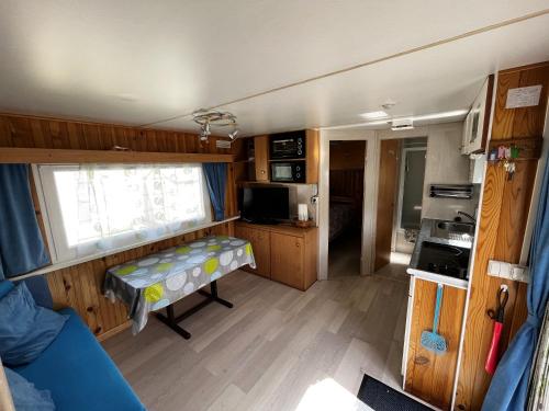 a small room with a kitchen and a living room at Bungalow charmant à Cauterets avec vue sur la montagne in Cauterets