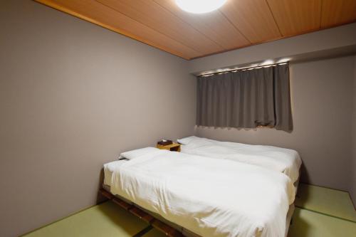 Ένα ή περισσότερα κρεβάτια σε δωμάτιο στο Randor Residence Tokyo Classic