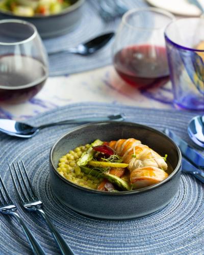 a pan of food with corn and shrimp on a table at OBLU SELECT Lobigili - Premium All-Inclusive with Free Transfers in Male City