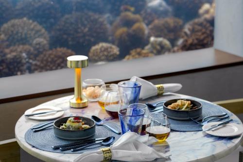 a table with plates of food and glasses of wine at OBLU SELECT Lobigili - Premium All-Inclusive with Free Transfers in Male City