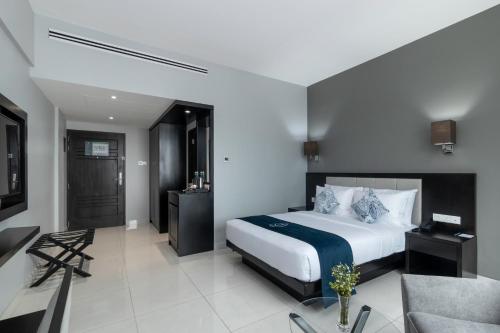 a bedroom with a bed and a living room at MaRadha Colombo in Colombo