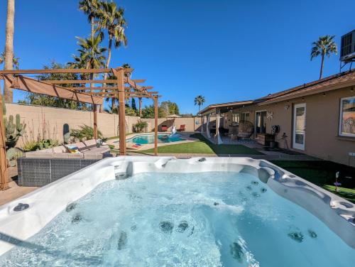a hot tub in the backyard of a house at Scottsdale Designer Oasis - Private Pool & Insta Getaway in Scottsdale