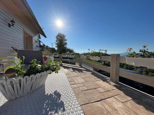 a patio with a fence and some plants on it at Dom pod kogutem in Laliki