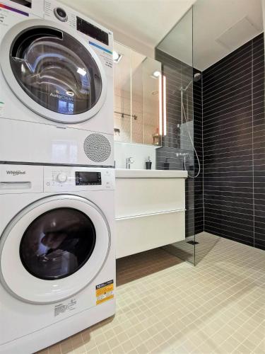 a washer and dryer in a bathroom at Scandian Apartments - City Hub Tallinn in Tallinn