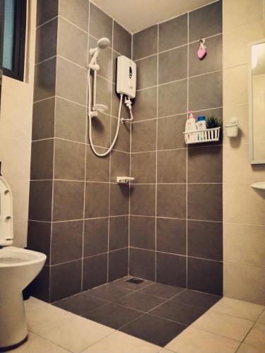 a bathroom with a shower with a toilet at Sara Staycation in Kajang