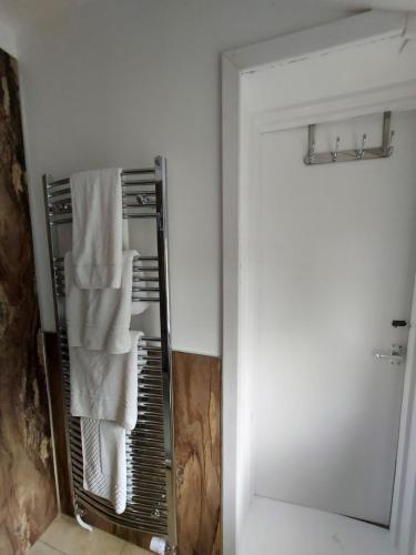 a towel rack in a bathroom with a mirror at Norwood Guesthouse-Loch Lomond in Balloch