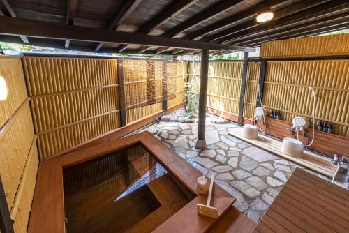 an inside view of a japanese room with wooden walls at ETAVIA Yufuin Kinrinko in Yufuin