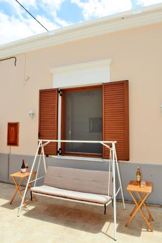 a bed in a room with a window at Classical Villa Archontiko D&M in Rhodes Town