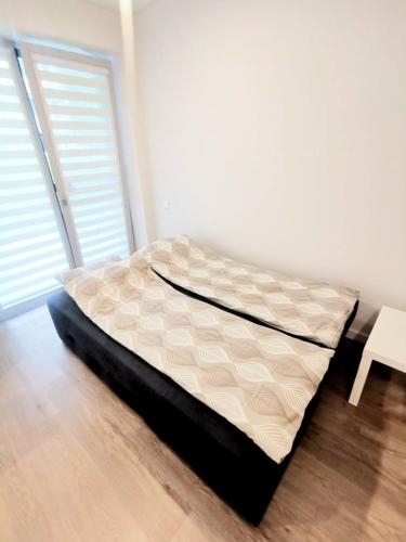 a bed sitting on the floor in a room at THINK POSITIVE ;) in Juodkrantė