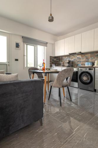 a kitchen with a couch and a table in a room at On The Breeze 1 in Kos