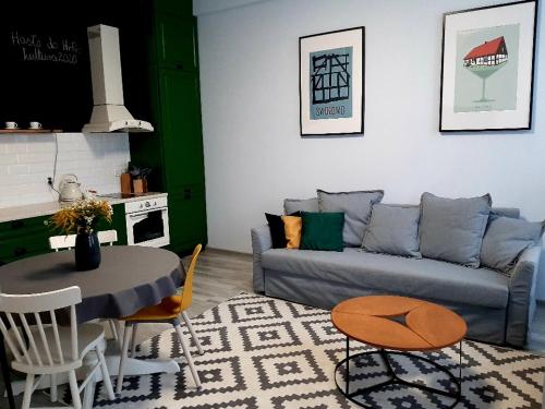 a living room with a couch and a table at Przystań Twórców in Słupsk