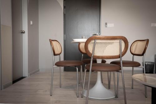 a group of chairs and a table in a room at Jesselton Quay by Pinstay in Kota Kinabalu