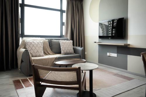 a living room with a couch and a table at Jesselton Quay by Pinstay in Kota Kinabalu