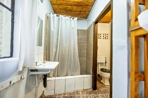 a bathroom with a sink and a toilet at Shoestrings Backpackers Lodge Vic Falls in Victoria Falls