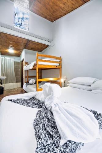 a bedroom with two beds and a bunk bed at Shoestrings Backpackers Lodge Vic Falls in Victoria Falls