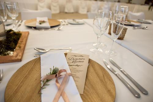 a table with a plate with a pair of scissors on it at Mont d'Or Swartberg Hotel in Prince Albert
