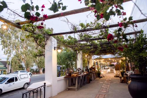 a white car parked in front of a store at Mont d'Or Swartberg Hotel in Prince Albert